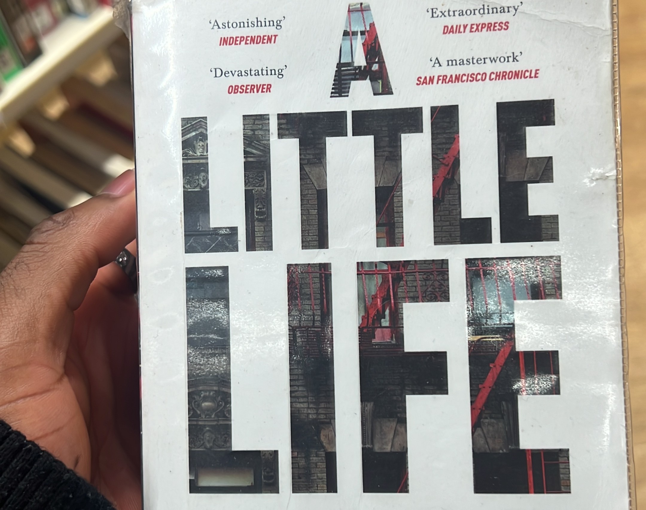 A picture of Zimuzo's hand holding a little life book